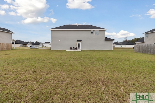 back of property featuring a lawn