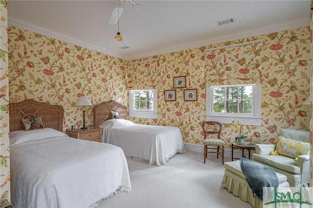 carpeted bedroom featuring ceiling fan and ornamental molding