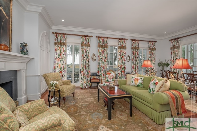 living room with a healthy amount of sunlight, wood-type flooring, and crown molding