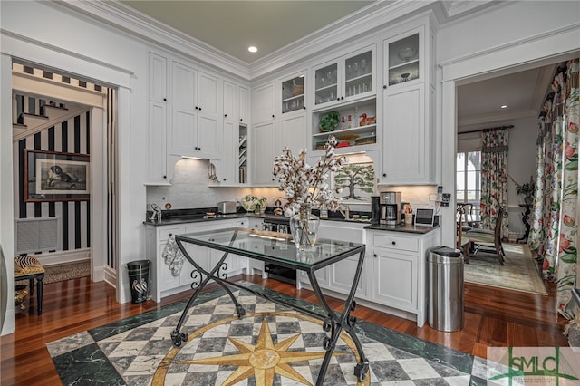 kitchen featuring dark hardwood / wood-style flooring, white cabinetry, and ornamental molding