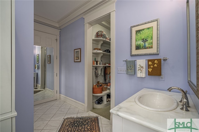 bathroom with tile patterned floors, vanity, and ornamental molding