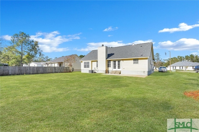 rear view of property with a patio area, a yard, and central AC unit