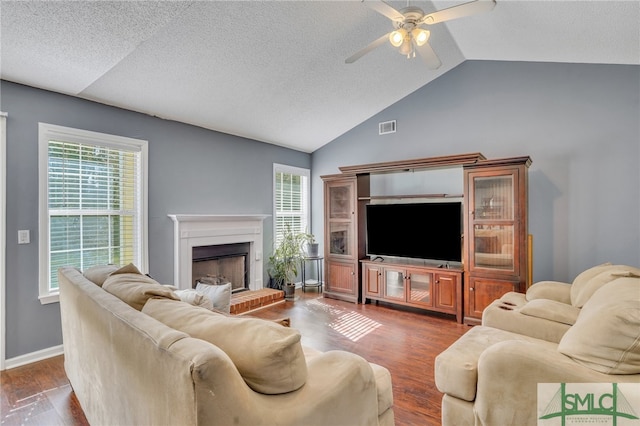 living room with dark hardwood / wood-style floors, lofted ceiling, and a wealth of natural light