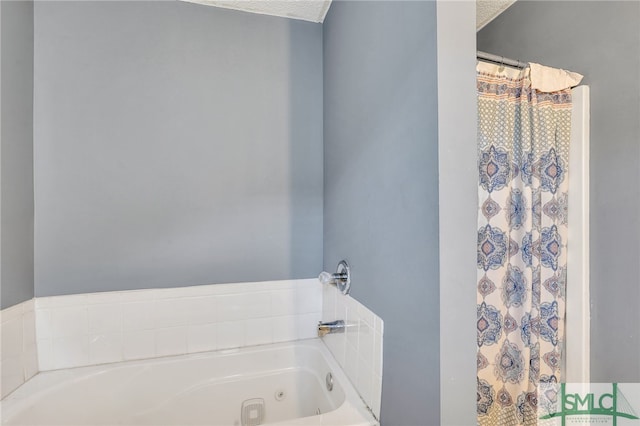 bathroom featuring a bath and a textured ceiling