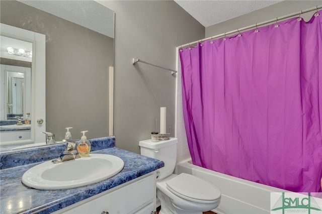 full bathroom featuring shower / bath combo with shower curtain, vanity, a textured ceiling, and toilet