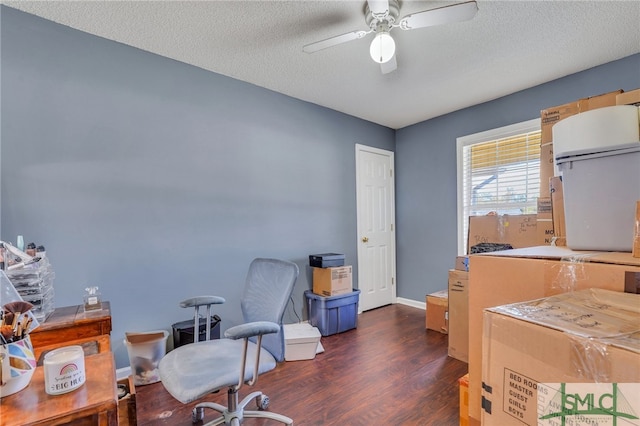 office space featuring a textured ceiling, dark hardwood / wood-style flooring, and ceiling fan