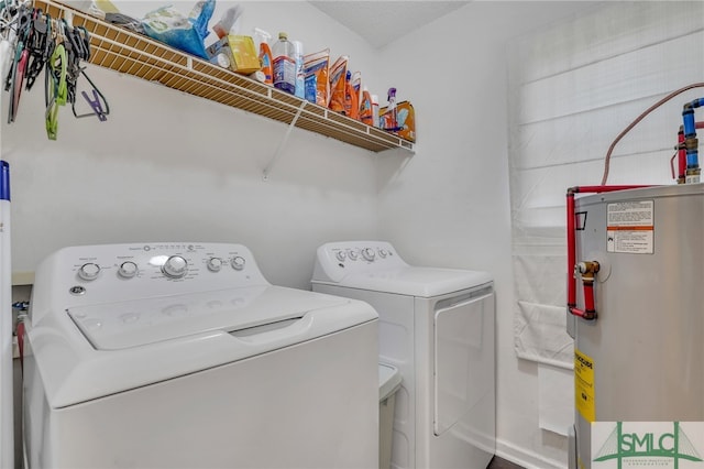 laundry room featuring washer and dryer, a textured ceiling, and water heater