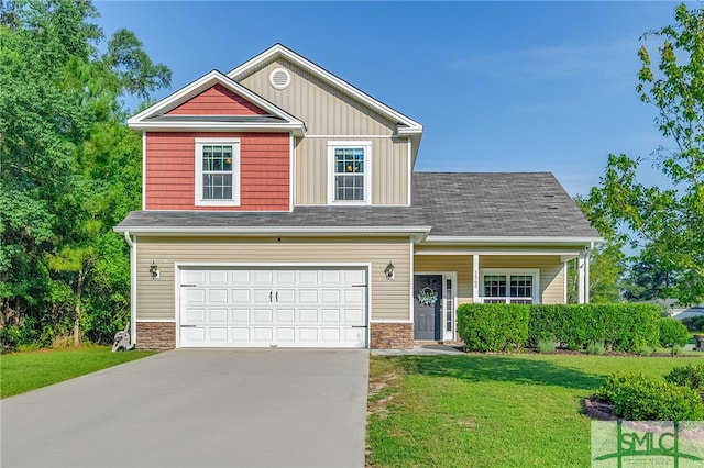 view of front of house with a front yard and a garage