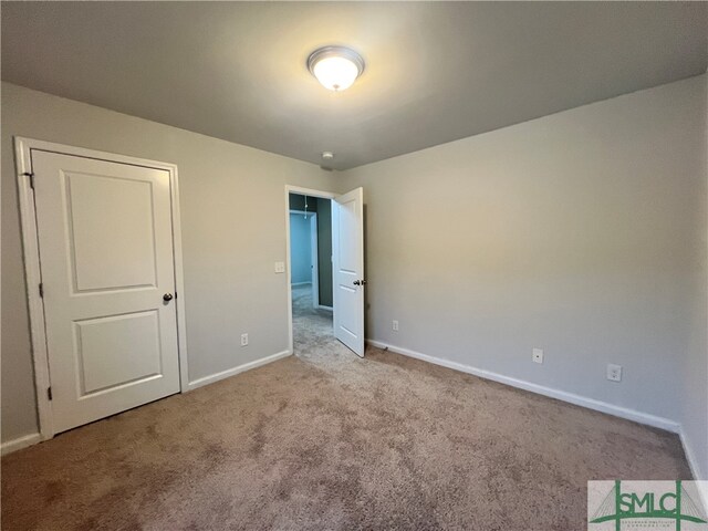 unfurnished bedroom featuring light colored carpet