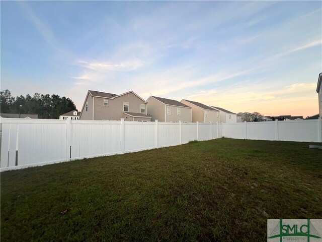 view of yard at dusk