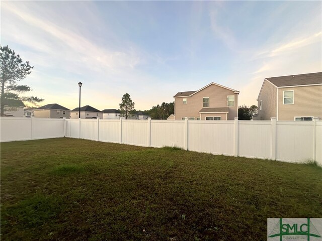 view of yard at dusk