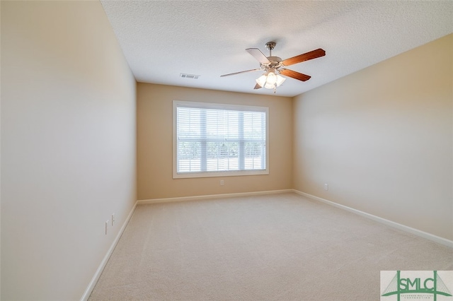 carpeted empty room with a textured ceiling