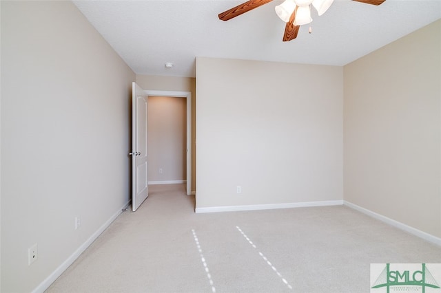 carpeted empty room with ceiling fan and a textured ceiling