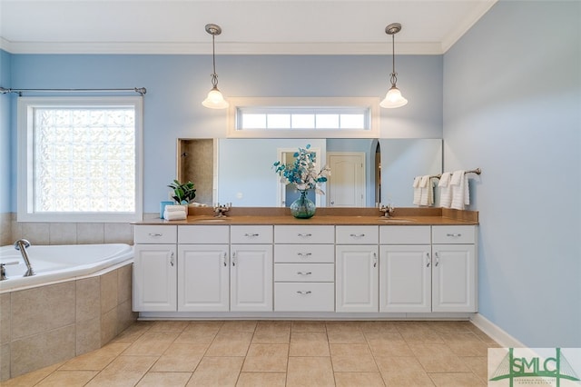 bathroom featuring plenty of natural light, tiled tub, and vanity