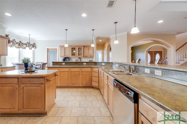 kitchen featuring stainless steel dishwasher, ornamental molding, a textured ceiling, sink, and a center island