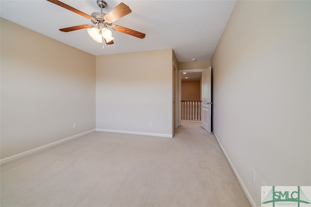 empty room with light carpet, a textured ceiling, and ceiling fan