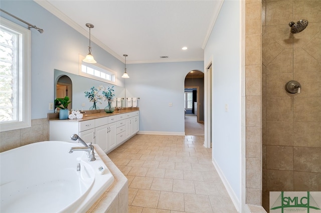 bathroom with plus walk in shower, vanity, plenty of natural light, and crown molding