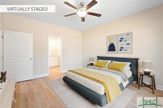 bedroom with ceiling fan, baseboards, wood finished floors, and ensuite bathroom