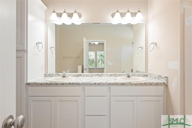 full bath with double vanity and a sink