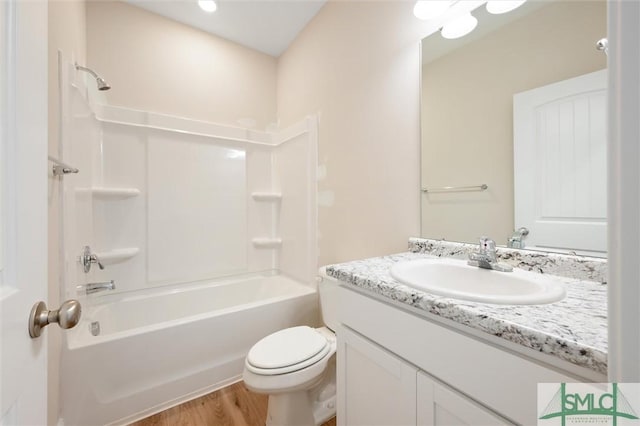 bathroom featuring shower / bathtub combination, wood finished floors, vanity, and toilet