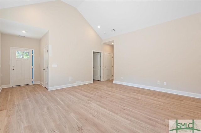 unfurnished living room featuring high vaulted ceiling, light wood-style flooring, recessed lighting, visible vents, and baseboards