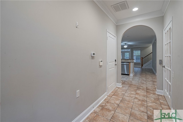 hall with crown molding and light tile patterned flooring