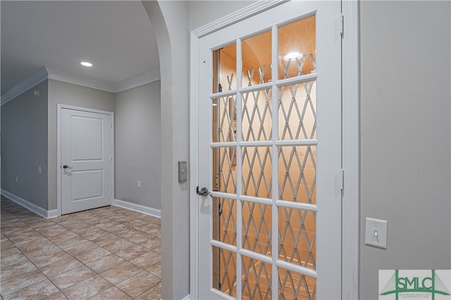 doorway to outside featuring crown molding