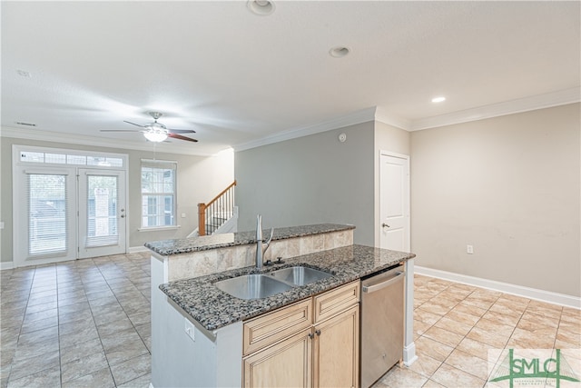 kitchen with sink, crown molding, dark stone countertops, stainless steel dishwasher, and a kitchen island with sink