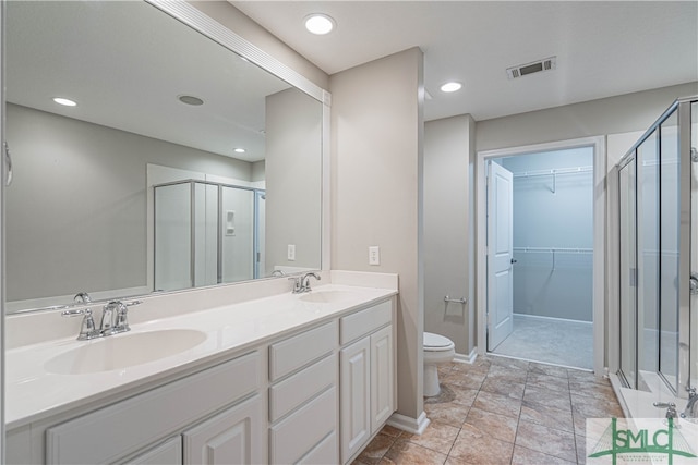 bathroom with vanity, toilet, and walk in shower