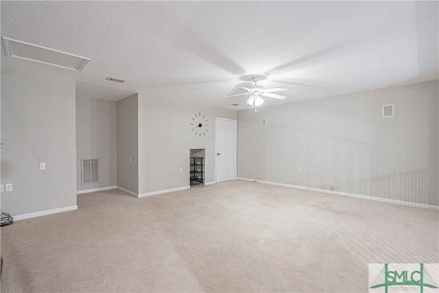 unfurnished living room with light carpet, a textured ceiling, and ceiling fan