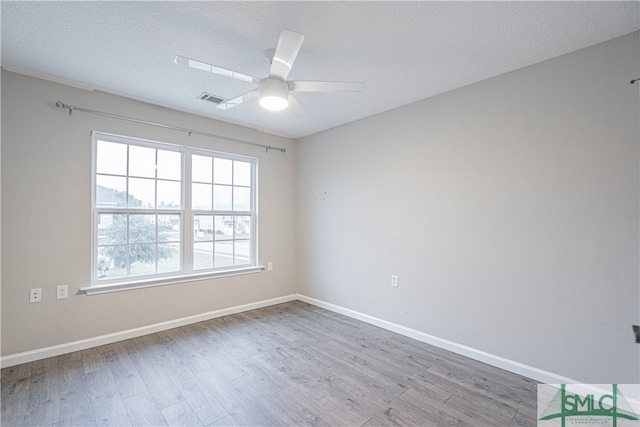 unfurnished room with hardwood / wood-style floors, a textured ceiling, and ceiling fan