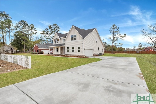 view of front of home featuring a front yard and a garage