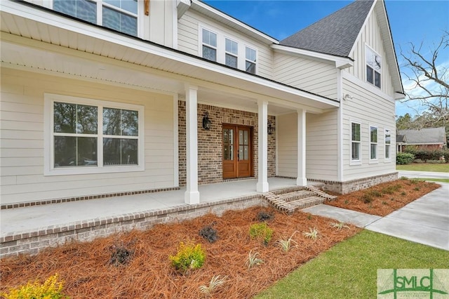 view of exterior entry with covered porch