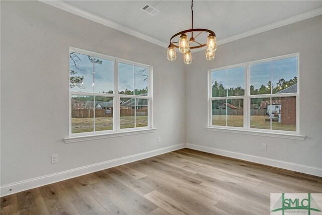 3250 Midland Rd, Guyton, GA 31312 - empty room featuring ornamental molding, a notable chandelier, visible vents, and wood finished floors