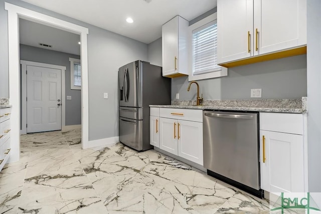 kitchen with sink, light stone counters, white cabinetry, and appliances with stainless steel finishes