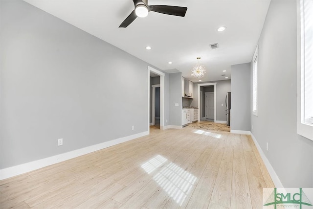 unfurnished living room with light hardwood / wood-style flooring and ceiling fan