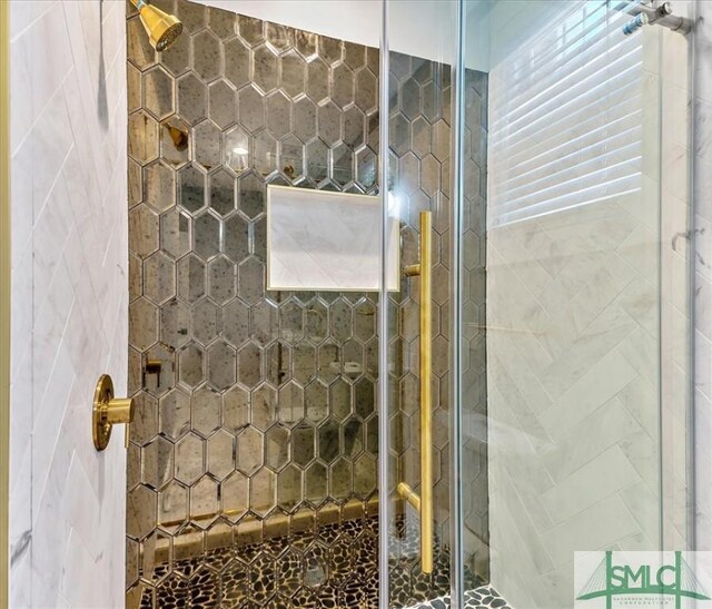 bathroom with a shower with shower door