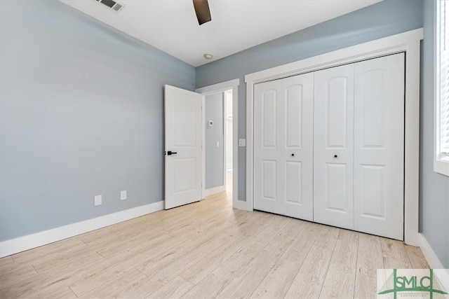 unfurnished bedroom with ceiling fan, light hardwood / wood-style floors, and a closet