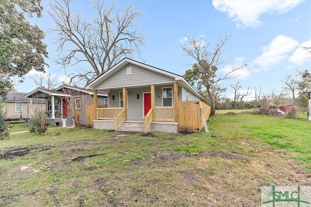 view of front of property with a porch and a front lawn