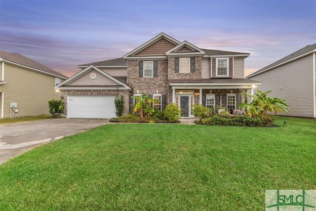 view of front of property featuring a garage and a lawn