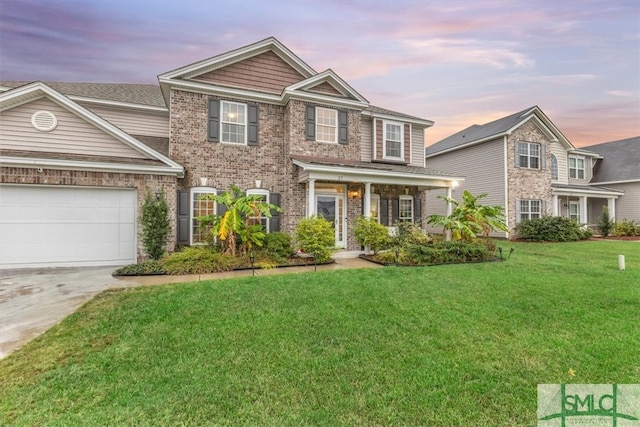 view of front of home with a garage and a yard