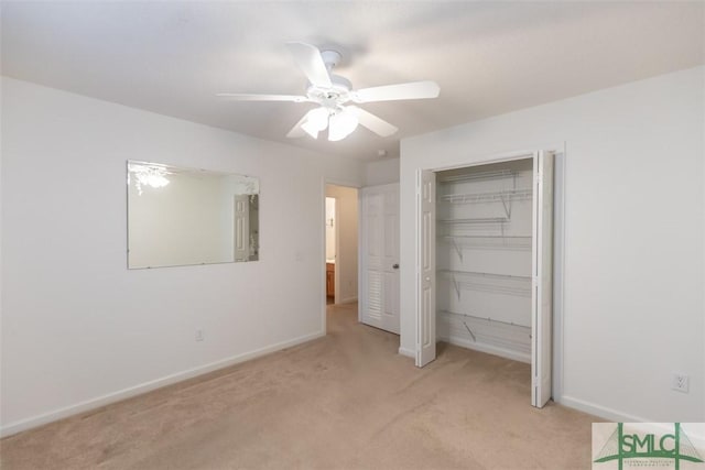 unfurnished bedroom with ceiling fan, a closet, and light carpet