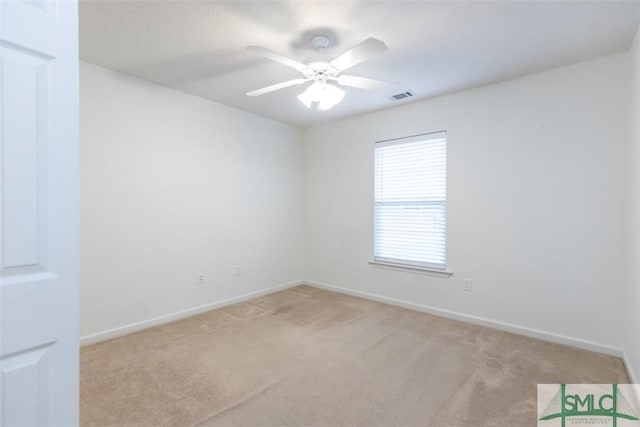 carpeted empty room featuring ceiling fan