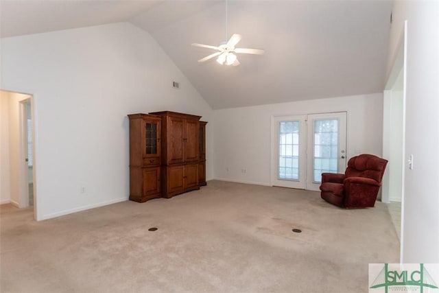 unfurnished room featuring ceiling fan, light carpet, and high vaulted ceiling