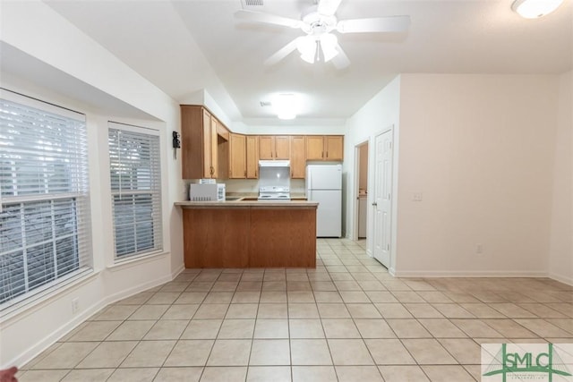 kitchen with kitchen peninsula, light tile patterned floors, white appliances, and ceiling fan