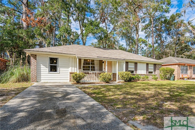 ranch-style home with covered porch and a front lawn