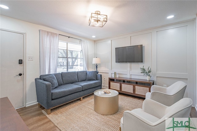 living room with light hardwood / wood-style flooring and a textured ceiling