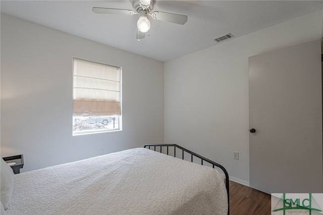 bedroom with ceiling fan and dark hardwood / wood-style flooring