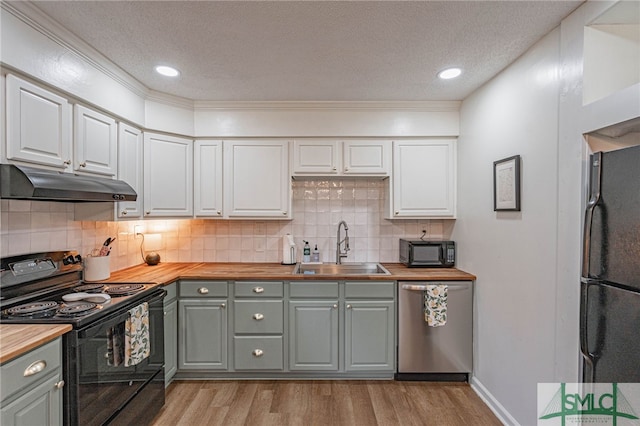 kitchen featuring black appliances, white cabinetry, wooden counters, and light wood-type flooring