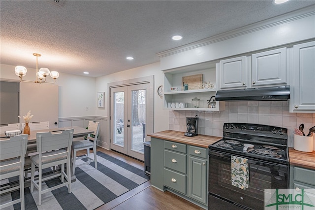 kitchen featuring french doors, dark wood-type flooring, decorative light fixtures, butcher block countertops, and black electric range oven